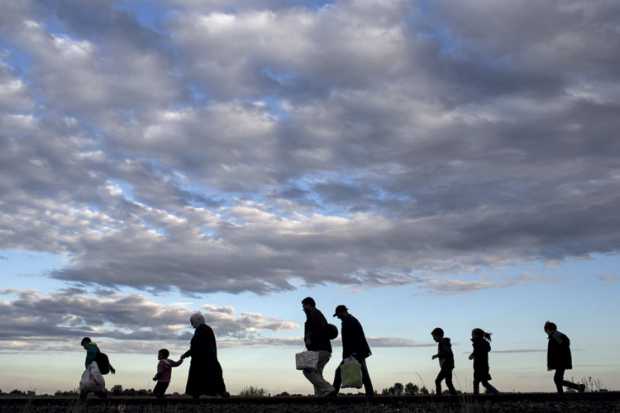 refugees-walking-across-a-field